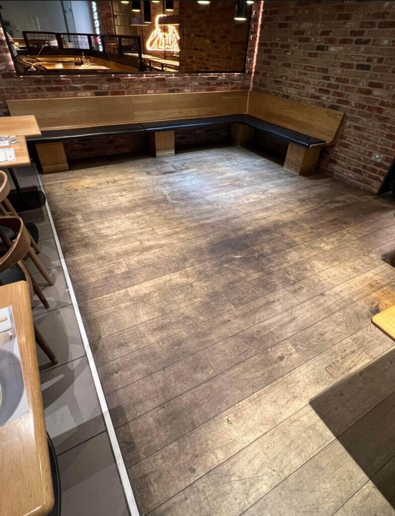 Dirty restaurant wooden floor before cleaning