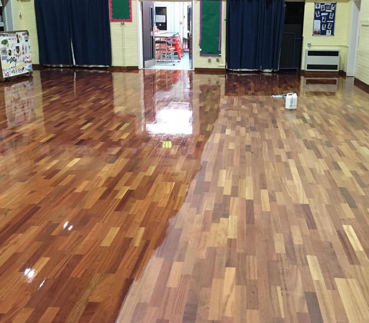 School hall cleaning a large wooden school hall with half of it polished and half of it dusty.